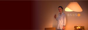"Woman adjusting LED lighting with wall switch, showcasing warm ambiance from large LED lamp and customizable brightness options in cozy bedroom setting."