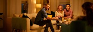 "Warm LED lighting creates cozy ambiance for friends socializing in living room, highlighting energy-efficient illumination for evening gatherings."