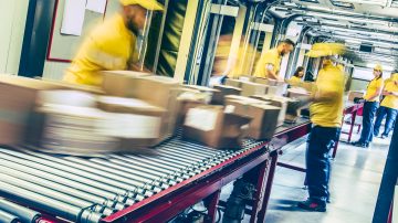 Assembly line workers with boxes