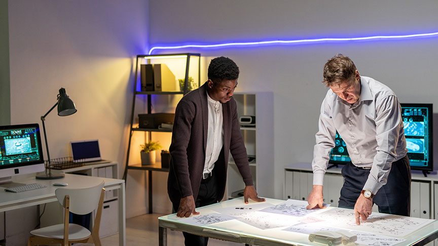 Two people reviewing plans in a modern office