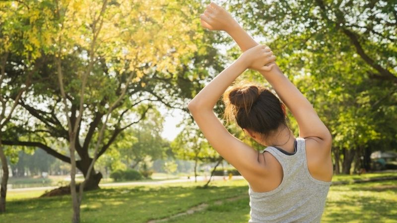 A woman sporting and stretching outdoors