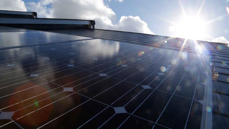 Solar panels, sun and blue sky