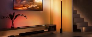 An image of a TV surrounded by orange tones of light promoting Hue sale