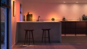 Smart LED kitchen lighting installed above and below cabinets, casting adjustable colored light onto countertops and walls.