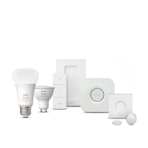 White Hue Smart Light Starter Kit bulb with rounded shape, wireless dimmer switch, and compact hub with matte finish and visible control button. 