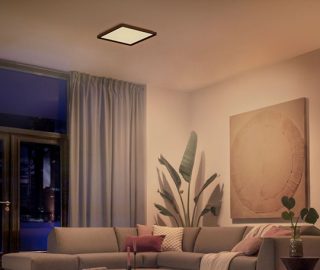 A Philips Hue square ceiling light illuminating a living room with soft white light.