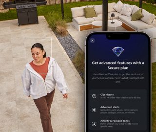 A woman in a backyard viewed through a Hue security camera with an inset of Hue Secure home security plans in the Hue app. 