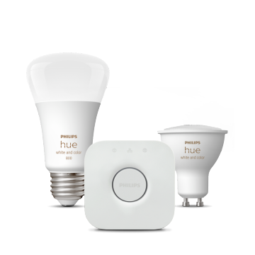 A set of smart lighting products including two white and color bulbs and a square wireless hub, all with a consistent modern design.