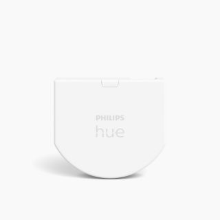 Wall switch module, compact rectangular and half-round shape, white color with matte finish, visible text reads ""PHILIPS hue"".
