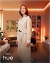 Person in a  living room with  Philips Hue ambient lighting.
