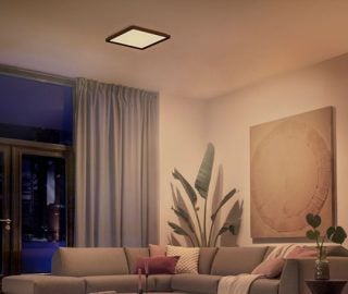 A Philips Hue square ceiling light illuminating a living room with soft white light.