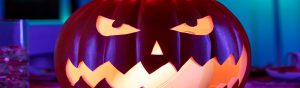 Halloween lighting ideas showing a haunted house exterior lit with Philips Hue outdoor lights for spooky Halloween decorations