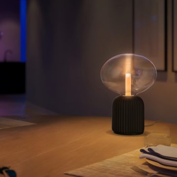 Triangular smart bulb in table lamp in living room with chair