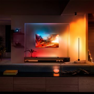 TV hanging on wall in living room surrounded by colourful lights