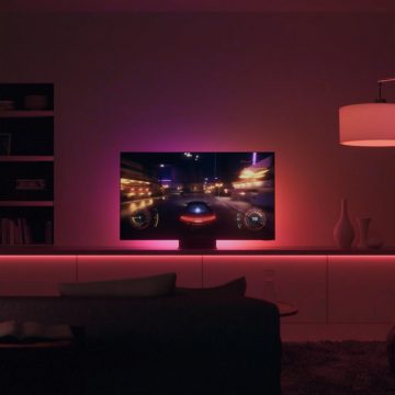 TV playing a racing game in living room with pink and red lights