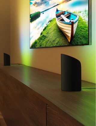 Two Hue Play wall washer gradient lights each side of a TV setup with entertainment lighting, 