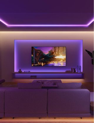 A living room and TV entertainment lighting set up lit with gradient strip lights glowing in purple and blue tones. 