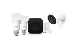 A collection of smart light bulbs, a hub, sensors, and a security camera, all in white and black, displayed against a plain background.