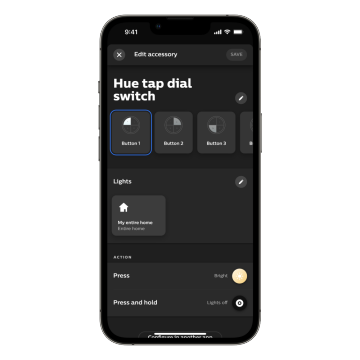 A smartphone screen displays the Hue app's ""Hue tap dial switch"" settings, showing button customization and light control options.