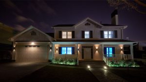 A house at night with illuminated windows in blue and white, creating a soft ambient glow on the porch and garden area.