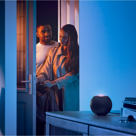 Man and woman in doorway lit by blue smart LED strip