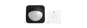 Two square-shaped motion sensors, one black with a dome lens and one white with a round lens and small sensor above.