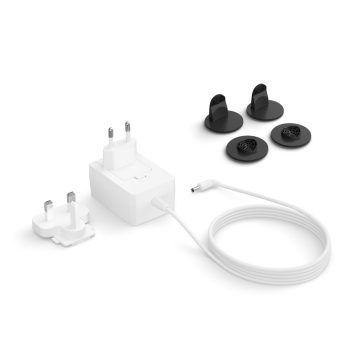 A white power adapter with interchangeable plugs, a white cable, and a collection of black mounting clips on a white background.