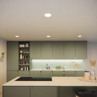 Ceiling recessed lights installed above a kitchen countertop, emitting bright illumination onto cabinets and workspace below.