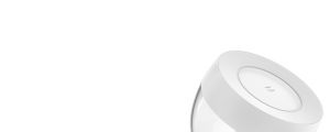 White smart table lamp with rounded compact shape and matte finish, top surface displays ""hue"" text, no visible switches or ports.