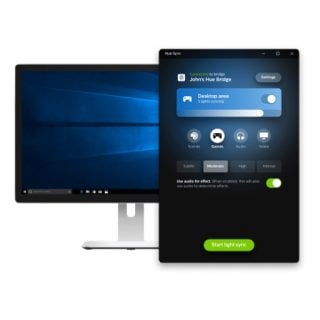 Hue Sync app interface on a computer monitor, showing Games mode selected, audio sync enabled, and Start light sync button.